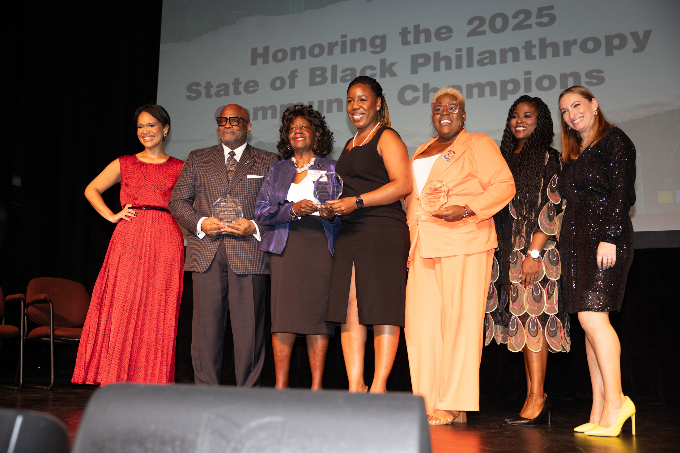 Honorees all smile on stage with their awards