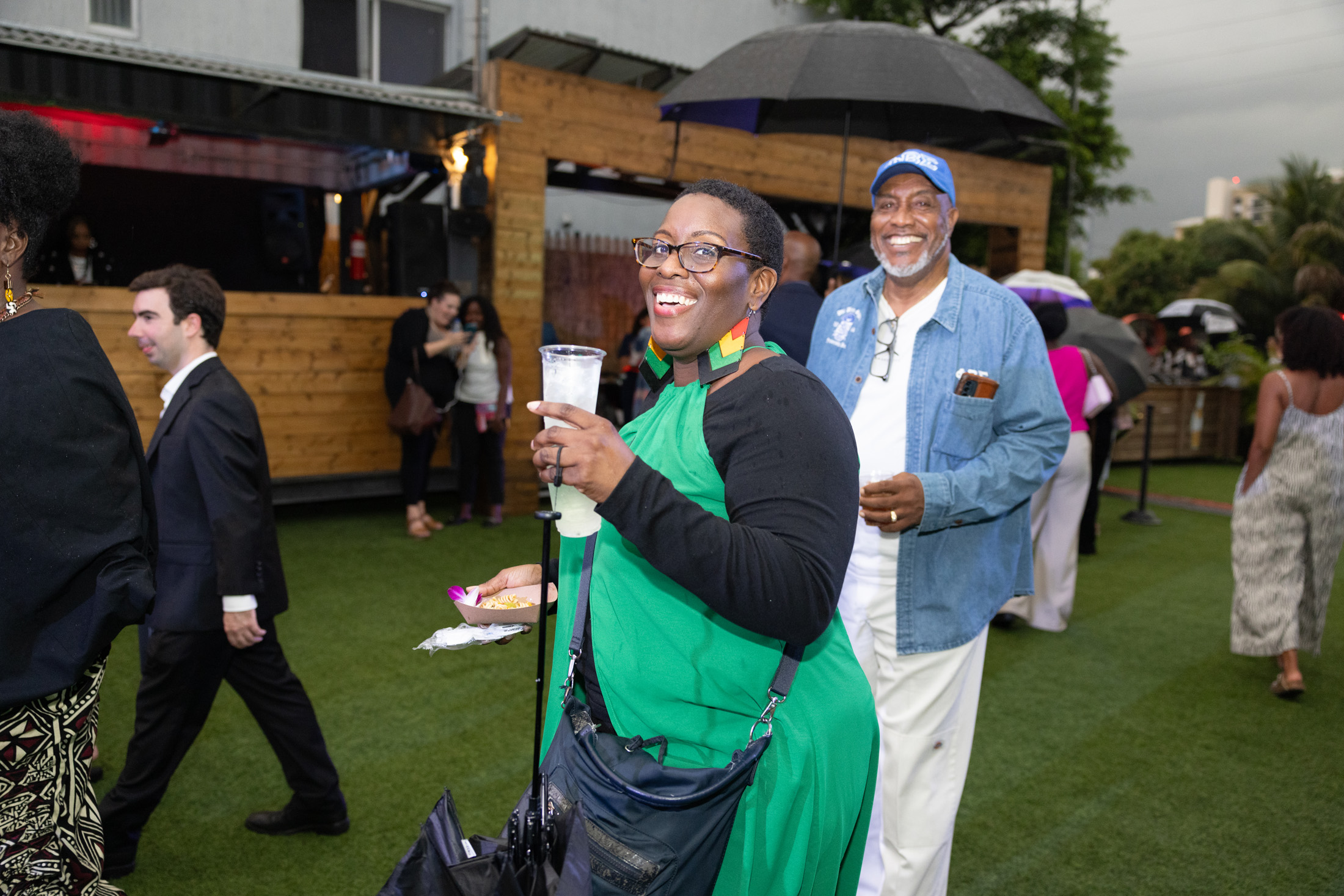 Attendees at The Urban enjoy a rainy evening