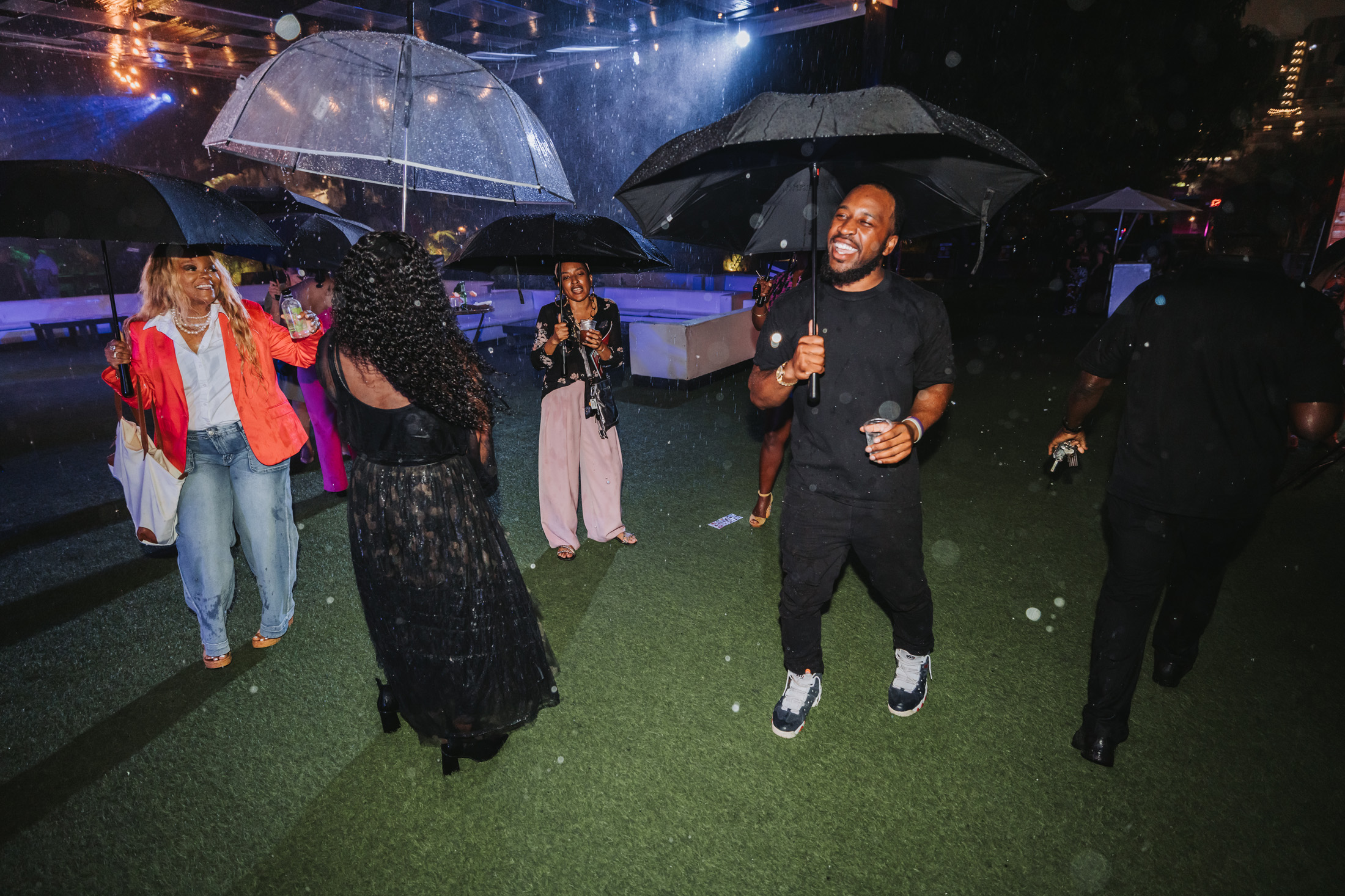 Attendees dance under umbrellas at The Urban.