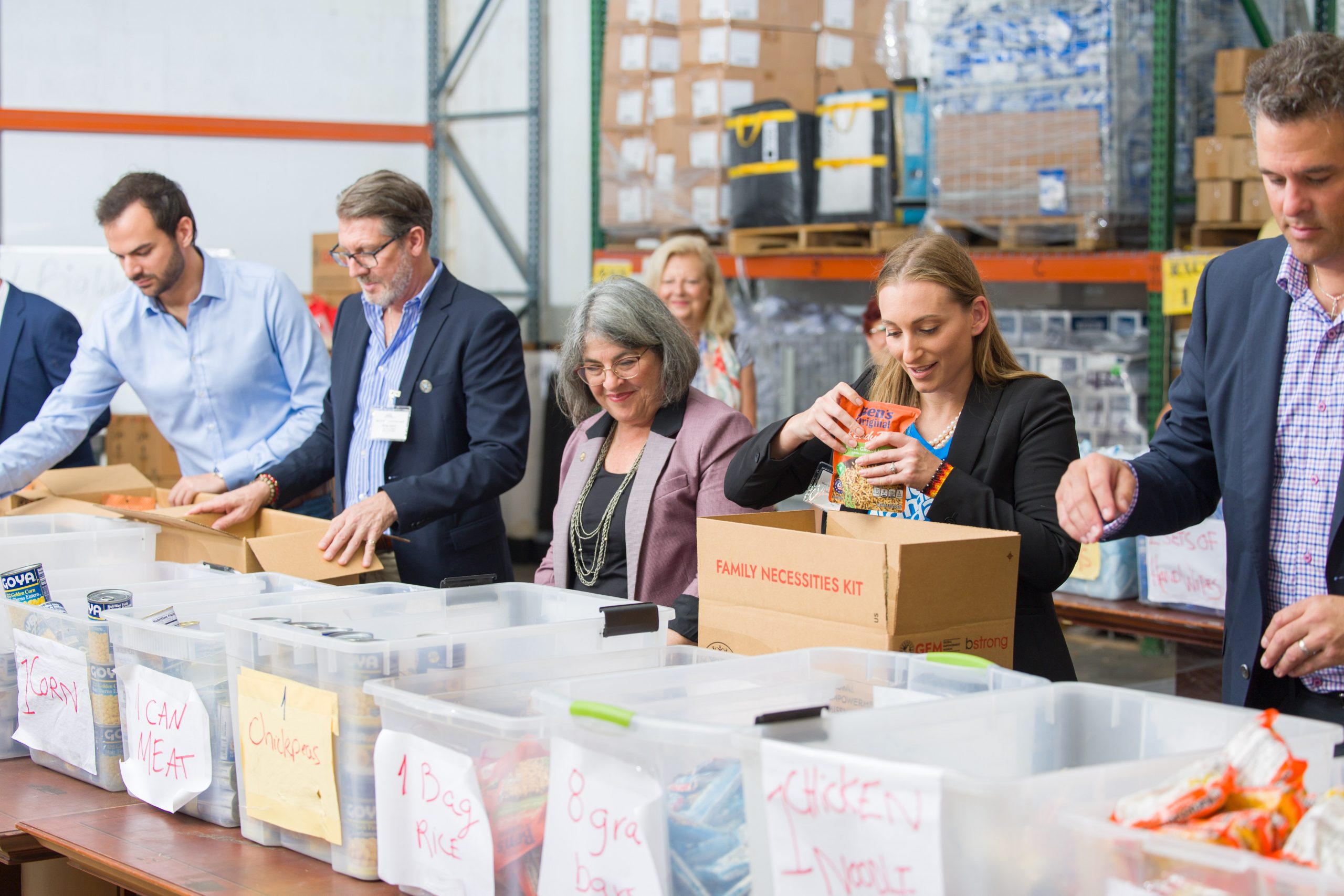 Community leaders assist in packing emergency supplies at the Global Empowerment Mission warehouse.