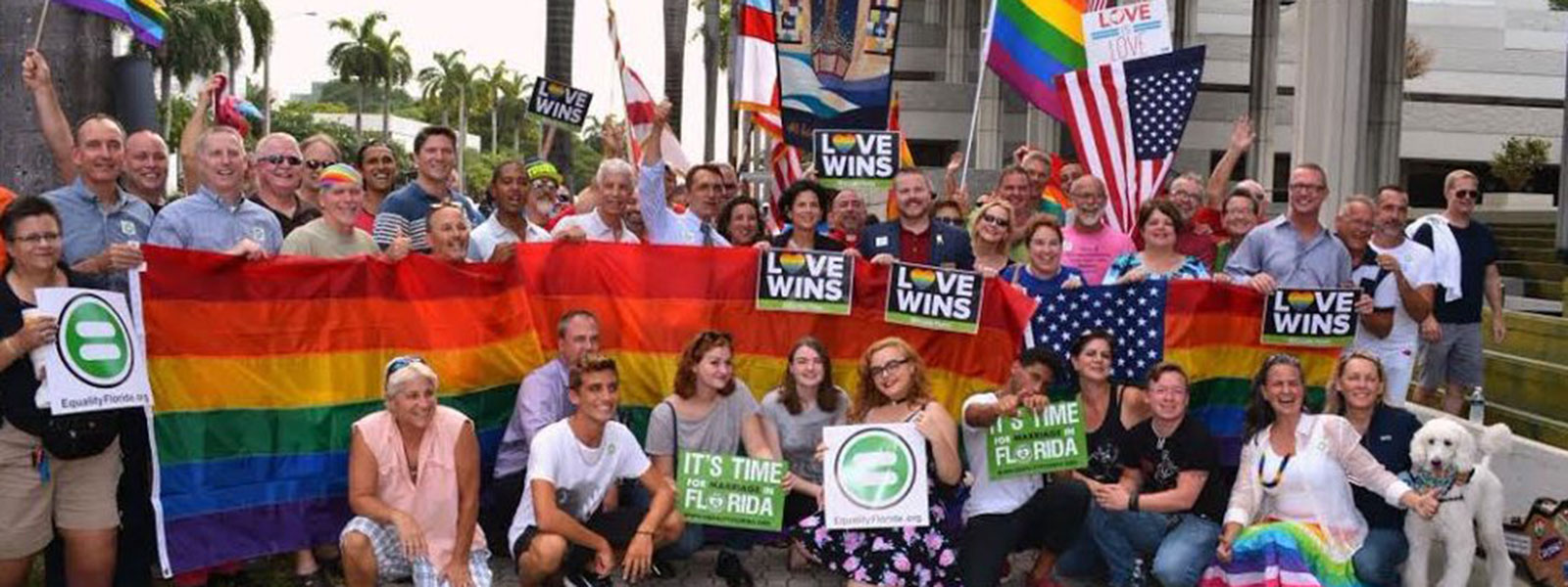 People standing with pride flag and signs that say "Love Wins" | 2016 GLBT Community Projects Fund Grantees People standing with pride flag and signs that say "Love Wins" | 2016 GLBT Community Projects Fund Grantees