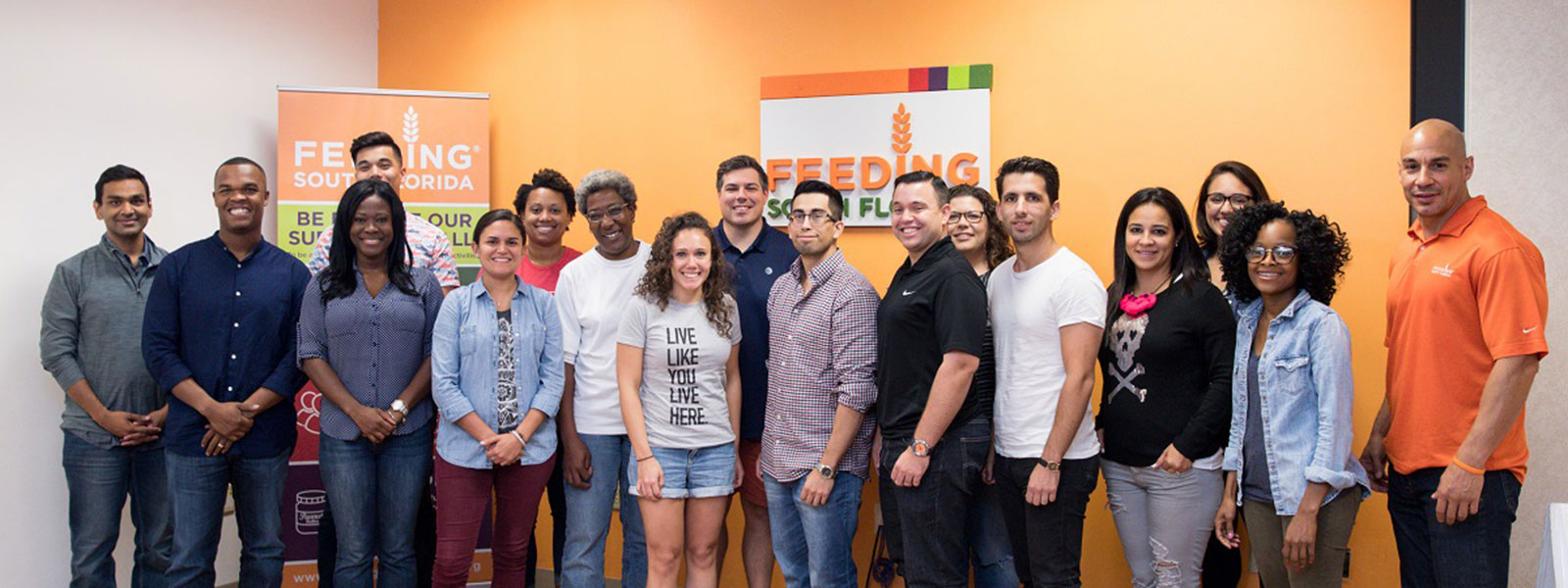 Group of smiling people in front of Feeding South Florida | Miami Fellows