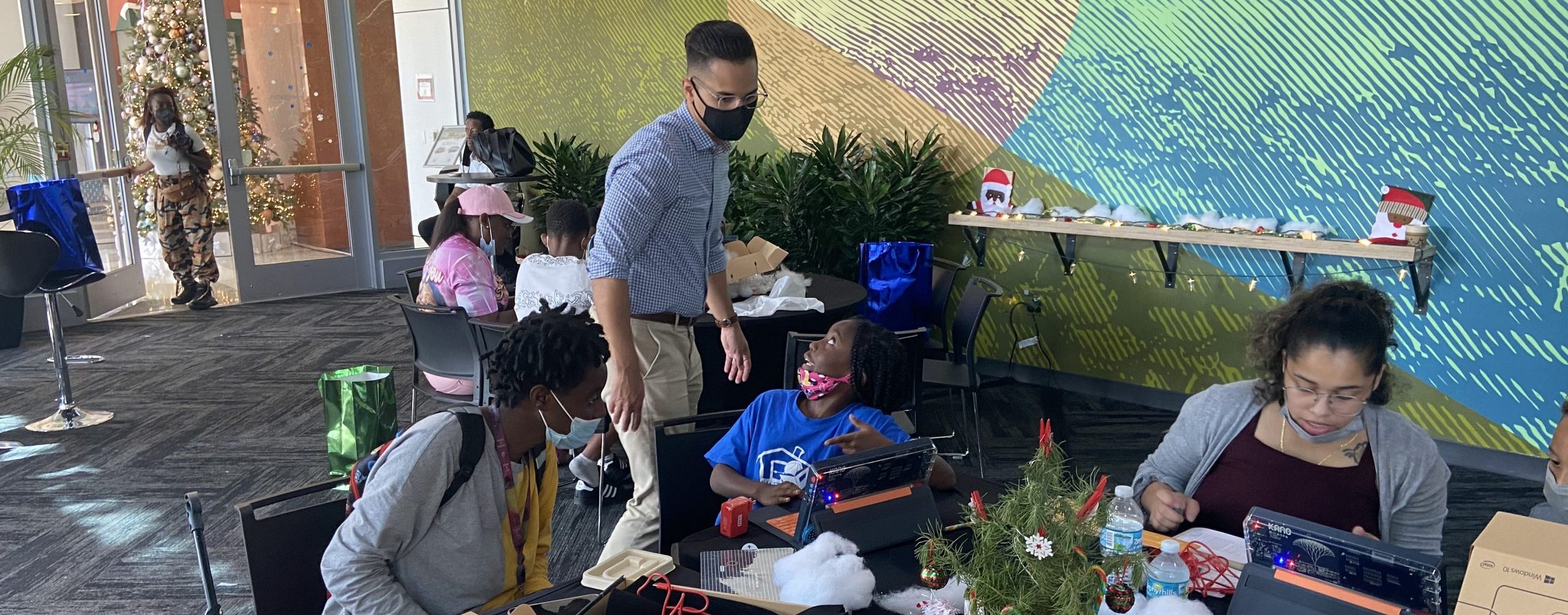Jorge Gonzalez, Director of Digital Access, and students with laptops