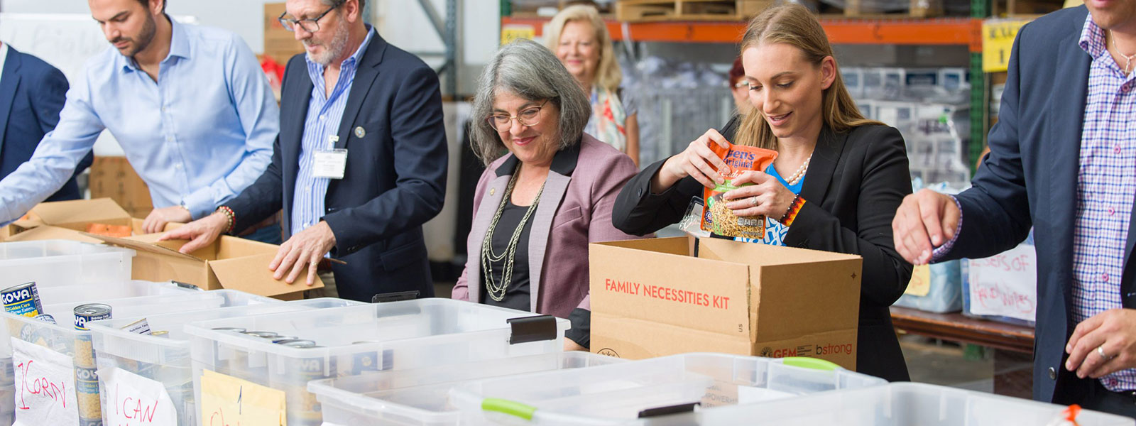 Miami-Dade County Mayor Daniella Cava and other people packing boxes of food Miami-Dade County Mayor Daniella Cava and other people packing boxes of food