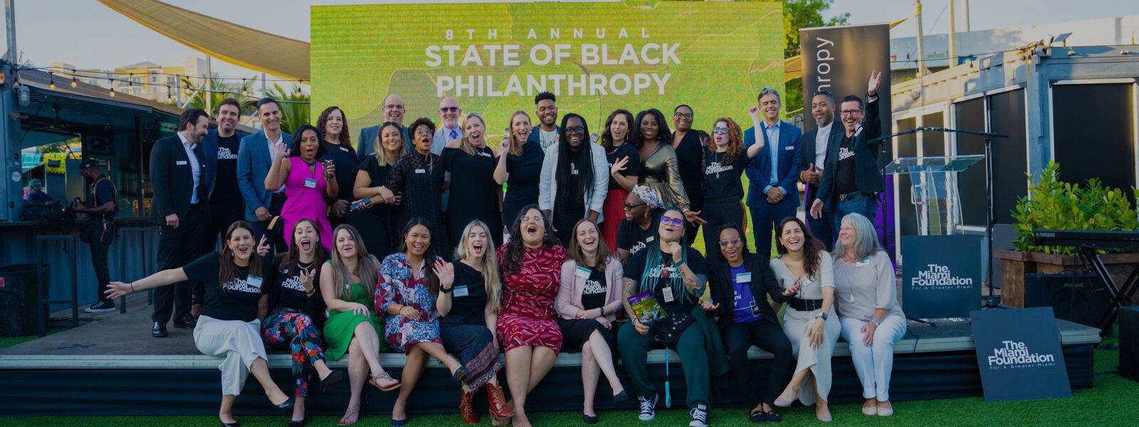 Group of people standing in front of 8th Annual State of Black Philanthropy sign Group of people standing in front of 8th Annual State of Black Philanthropy sign