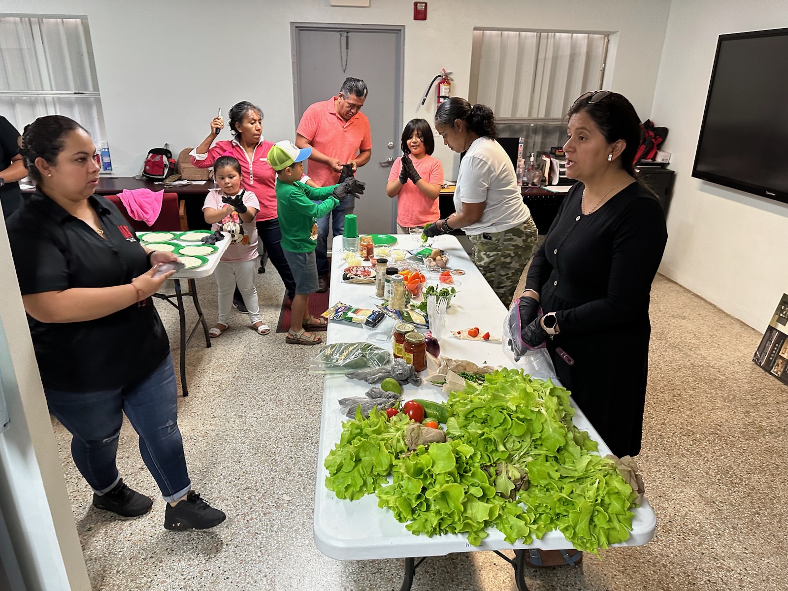 Volunteers sort through produce for packaging.