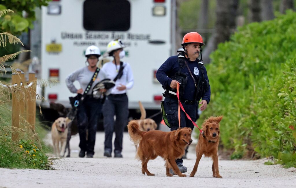 Rescue workers with dogs at the Surfside building collapse in 2021