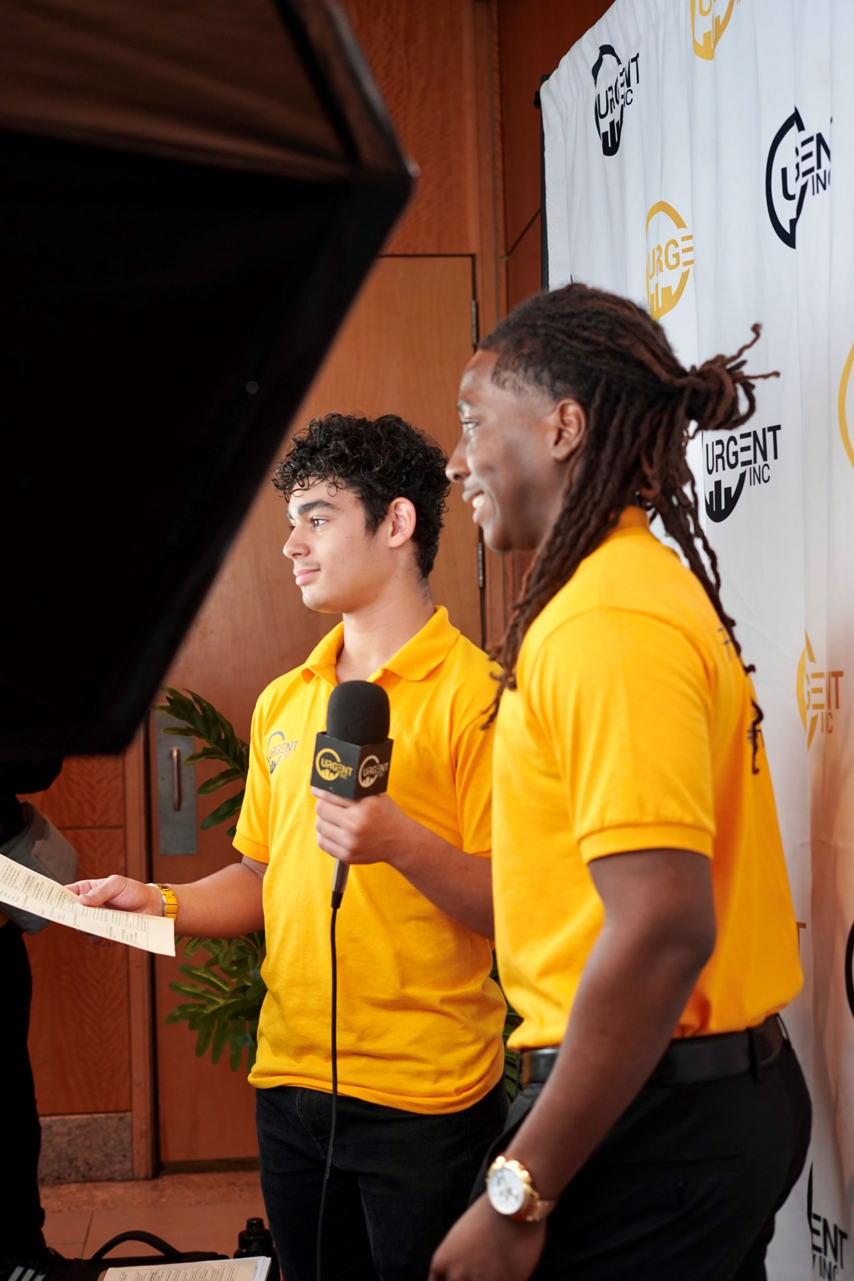 Student reporters smile as they record a segment.