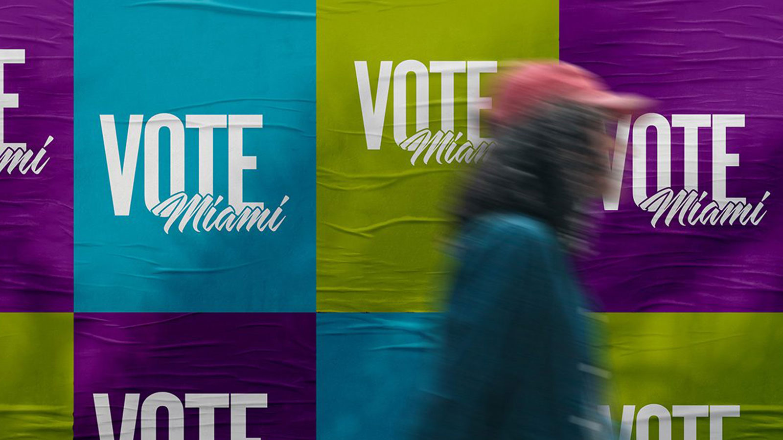 Person walking past Vote Miami sign